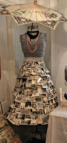 a dress made out of newspapers and an umbrella