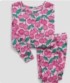 This adorable baby pajama set from Gap features a playful cherry theme and is made from 100% organic cotton. The set includes a long-sleeved top and pants, both in a pretty pink color. It is sized for babies 12-18 months and comes with tags attached. The pajama set is perfect for keeping your little one cozy and comfortable during sleep time. It is a great addition to any baby's wardrobe and makes a lovely gift for new parents. Pink Cotton Sleepwear For Spring, Playful Pink Cotton Sleepwear, Pink Cotton Sets With Strawberry Print, Cute Pink Strawberry Print Sets, Pink Bedtime Sets For Spring, Pink Spring Bedtime Sets, Spring Strawberry Print Sleepwear For Loungewear, Sweet Cotton Long Sleeve Sets, Sweet Long Sleeve Cotton Sets