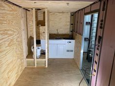 the inside of a tiny house with wood paneling