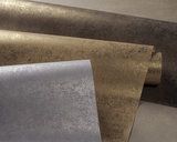 three different types of metal sheets stacked on top of each other, one is gold and the other silver