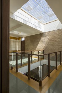 an indoor swimming pool with skylights and glass railings in the middle of it