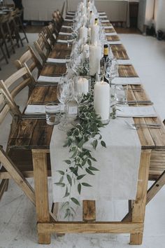 the table is set with candles and place settings for guests to sit down at it