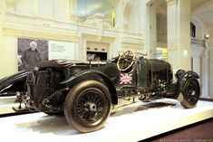 an antique car on display in a museum