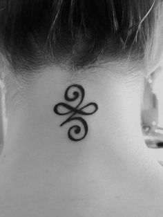 a black and white photo of a woman's neck with a tattoo on it