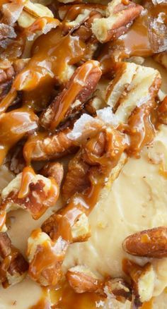 there is some kind of desert with nuts on it and caramel sauce drizzled over the top