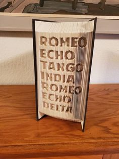 an open book sitting on top of a wooden table