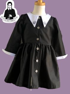 Cotton Fitted Dress With Doll Collar, Fitted Cotton Costume Dress, Cotton Fitted Dress With Peter Pan Collar, Black Cotton Dress For Costume Party, Cotton Short Sleeve Dress For Costume Party, Long Sleeve Cotton Dress For Costume Party, Cotton Dress With Peter Pan Collar And Buttons, Black Cotton Costume Dress, Bowie Dress