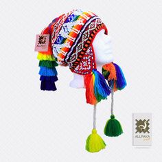 "This colorful Chullo is a handmade hat made by indigenous from the Andes in Pisac Cusco - PERU, woven in multicolored wool yarn, with ear flaps and decorated with beads all around, which are sewn one by one. This particular one has a design of the \"Andean Llama\",South American camelid from the Andean cultures. If laid flat, the Chullo alone is approximately 12\" long x 10.5\" wide. Including the pompoms on the bottom and all of the top, it measures from end to end 24\" approximately The CHULL Cusco Peru, Wool Thread, Ear Hats, Handmade Hat, Lace Collar, Alpaca Wool, Lace Edging, Sheep Wool, How To Make Ornaments