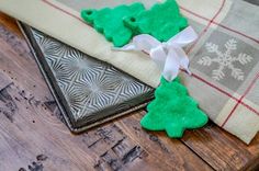 some green cookies are sitting on a table