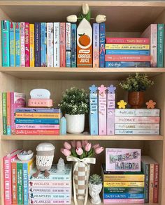 a book shelf filled with lots of books and vases on top of each other