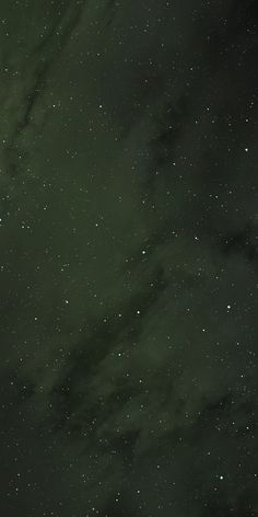 the night sky is filled with stars and green hued clouds, as well as white dots