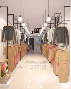 the inside of a clothing store with clothes on racks