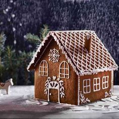 a gingerbread house is decorated with icing