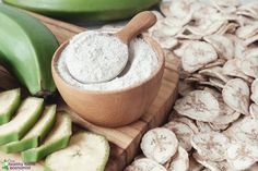 a wooden bowl filled with powder next to sliced bananas