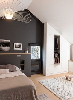 a bedroom with black walls and white furniture