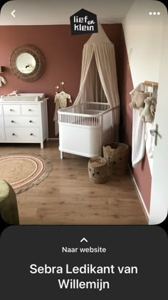 there is a baby crib in the room with pink walls and white furniture on the floor