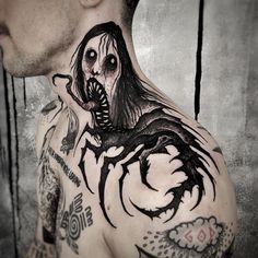 a man with tattoos on his neck and chest