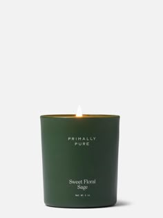 a candle that is sitting on top of a white surface with the words sweet floral sage written