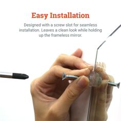 a person holding a screw in their left hand with the caption easy installation designed with a screw for seamless installation leaves a clear look while holding up the