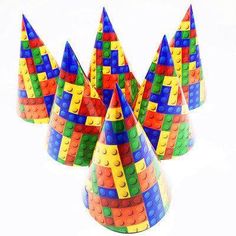 four plastic cups with legos on them in the shape of cone toppers,