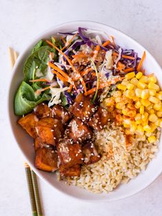 a white bowl filled with rice, meat and veggies