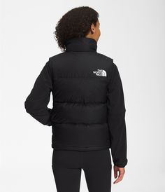 Details: At home in the mountains or the city, the Women’s 1996 Retro Nuptse Vest is a cold-weather icon for good reason. This ultra-warm layer has a durable ripstop outer, oversized down baffles, and can be stowed in its right-hand pocket when temperatures rise. Features Relaxed fit with a boxy silhouette Inspired by the iconic design lines of our 1996 Nuptse Vest Original shiny ripstop fabric for durability Non-PFC DWR finish for added water repellency 700 fill down offers warmth yet remains e Nuptse Vest, The North Face 1996 Retro Nuptse, The North Face 1996, North Face 1996, Ripstop Fabric, Vest Outfits, Shorts With Tights, Hush Puppies, Workout Accessories