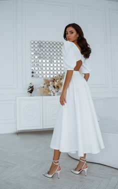 A captivating White Backless Puff-Sleeve Midi Dress embellishes with features that give you a chic and elegant every moment.