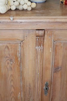 an old wooden cabinet with garlic on top