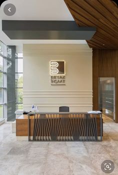 an office lobby with a large wooden desk