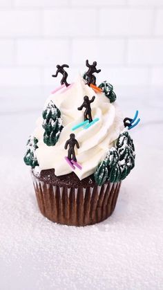 a cupcake with white frosting and decorations on top