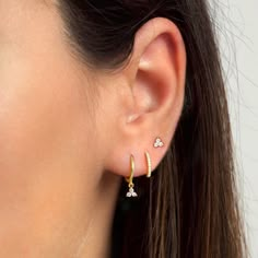 "Dainty and beautiful, these tiny studs are adorned with three bright prong-set cubic zirconia gemstones. An everyday staple piece, perfect for wearing in a first, second or third earhole or on a cartilage piercing for a dainty addition to your look. * Sold as a PAIR * D E T A I L S * ∙ Material: .925 Sterling Silver or 18K Gold Plated over .925 Sterling Silver ∙ Stone: White Zirconia ∙ Dimensions: 4mm ∙ Hypoallergenic & nickel-free * P A C K A G I N G * ∙ All jewelry is sent out beautifully 3 Holes Ear Piercing, Three Lobe Piercing Ideas, Earring Stacks Gold 2 Holes, Third Piercing Ideas, Second And Third Ear Piercing, Three Piercings Ears Ideas, Triple Ear Piercing Ideas, Styled Ears, Triple Ear Piercing