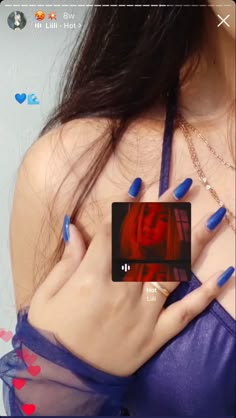 a woman with blue nail polish holding her hands on her chest and wearing a purple bra