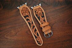 This is a 100% hand tooled watch strap with Sheridan style tooling, done on the highest quality natural veg tan in the US. This style of tooling is a traditional western art typically done during saddle making. hand dyed background to make the design stand out. Lined with soft, natural veg tan pigskin. Add some traditional leatherwork to your modern Apple Watch. -This strap is 22mm at the adapters, swells to around an inch or 3cm and tapers to an 18mm buckle. -Made to the standard watch strap size; 120mm point side and 80mm buckle side. If you would like custom sizing, please contact me, it should not be a problem. Please note that since the tooling is hand done, patterns may slightly vary from strap to strap. Tooled Leather Watch Bands, Leather Design Pattern, Saddle Making, Apple Watch Armband, Leather Apple Watch Strap, Apple Watch Bands Women, Apple Watch Leather Strap, Design Stand, Apple Watch Bands Leather