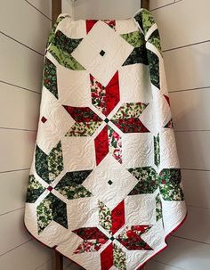 a quilted christmas tree skirt hanging on the wall