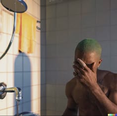 a man with green hair standing in front of a bathroom mirror holding his hands to his face