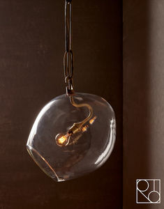 a glass light fixture hanging from a ceiling in a room with dark walls and wooden flooring