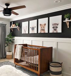 a baby's room with pictures on the wall and a crib next to it