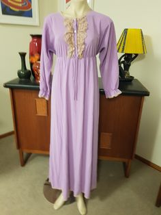 Romantic style long length night gown in a soft wash n wear ankle length. The night gown is in a nylon muted mauve with long sleeves and ruffle cuff, round neck with a lace ruffle in beige and bronze, three button closure,  empire line , and ankle length. The label is Diamond Cut and made in Australia. The size is 14au. The condition is very good with no faults found  Measurements are Shoulder to shoulder 43cm Bust approx 91cm Length shoulder to hem 144cm  Sleeves shoulder to cuff 56cm Long Sleeve Lace Sleepwear For Loungewear, Long Sleeve Lace Sleepwear For Lounge, Elegant Fitted Long Sleeve Sleepwear, Elegant Long Sleeve Lace Sleepwear, Fitted Long Sleeve Lace Sleepwear, Lace Long Sleeve Sleepwear For Wedding Night, Feminine Long Sleeve Lace Sleepwear, Fitted Long Sleeve Dress For Night, Spring Long Sleeve Gown With Lace Trim