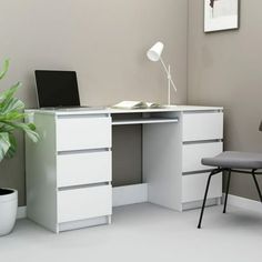 a white desk with a laptop on it and a chair in front of the desk