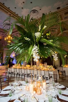 the centerpiece is surrounded by candles and greenery