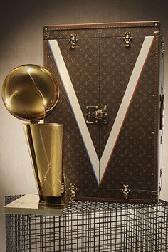 Louis Vuitton is the first official trophy case provider of the NBA. Designed by Virgil Abloh, the case features Louis Vuitton’s emblematic monogram canvas and harbors a large “V” in white with blue and red details. Click to learn more about the hand-crafted case. #hypebeast #louisvuitton #nba Nba Finals Trophy, V In White, Trophy Case, Louis Vuitton Travel, Red Details, Nba Logo, Brass Fixtures, Blue Interior, Creative Packaging