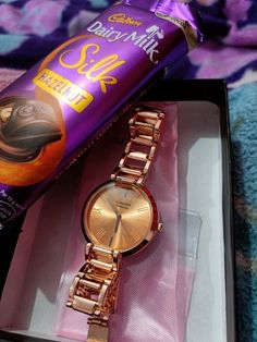 a watch and chocolate bar in a box