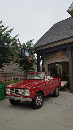 a red pick up truck parked in front of a house