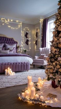 a bedroom decorated for christmas with candles on the floor and a tree in the corner