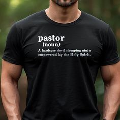 a man wearing a black shirt with the words pastor noun in white on it