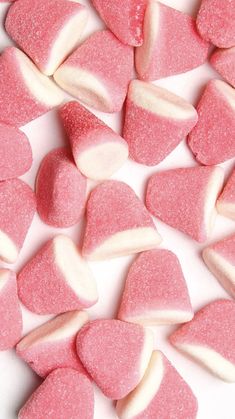 pink and white candy hearts on a white surface