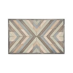 a wooden wall hanging with an abstract design on it's side, in grey and beige