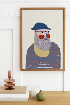 a portrait of a man with red nose and beard is hanging on the wall above a table