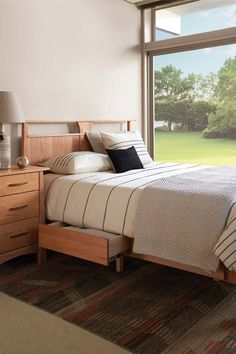 a bed sitting next to a window in a bedroom