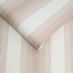 a close up view of a bed sheet with brown and white stripes